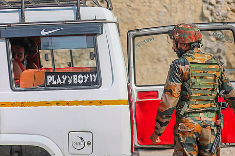 security official search a civilian vehicle